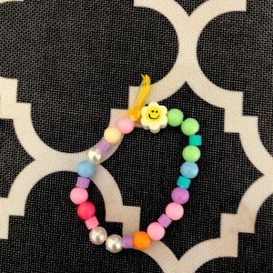 I am selling a bracelet with a smiley face flower